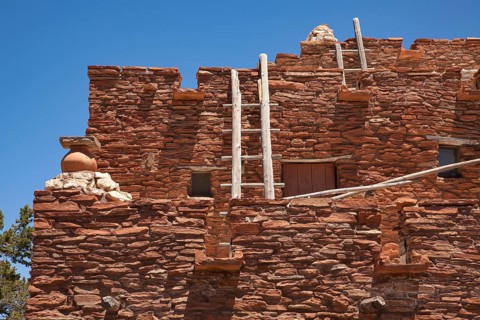 Southwestern hopi house 1905 architecture abstract with wooden ladders and clear blue sky