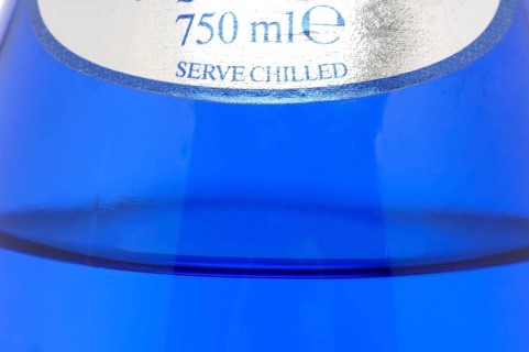 Glass with mineral water, small carbonated pearls on the edge of the glass, drinking water