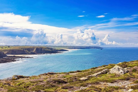 Seascape view at a seabay on a rocky coastline a sunny summer day by the sea with dramatic clouds