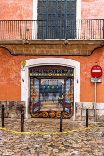 Restaurant with roll-down shutter blinds with graffiti painting on a street corner in the city,