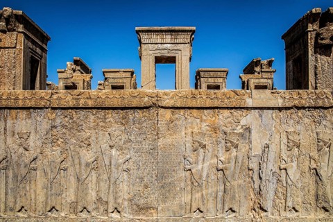 Persian wax soldiers on the western steps of the Darius Palace with cuneiform script, Persepolis