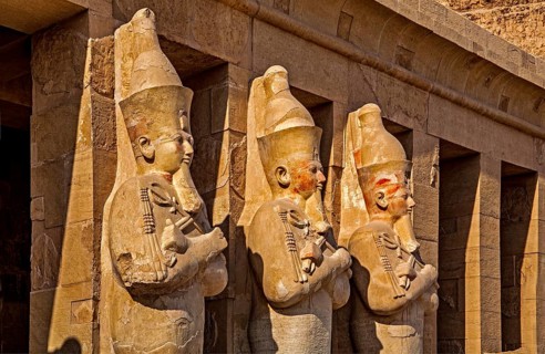 Osiris statues of Hatshepsut on the second terrace - partly with original paint remains, mortuary
