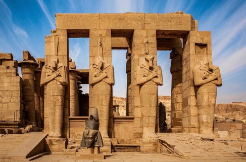 2nd courtyard with Osiris statues, head of a statue of Ramesses II in front of it, Ramesses II