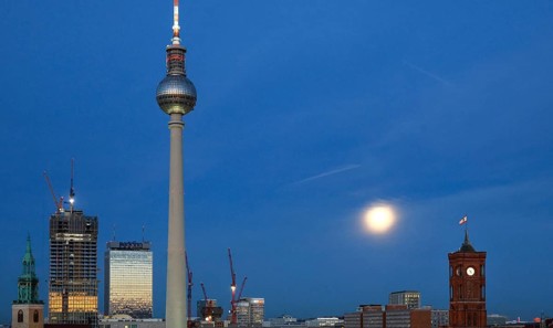 The moon shines on Alexanderplatz, St. Mary's Church, The Berlinian skyscraper construction site,