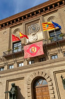 Flags flying Ayuntamiento city hall building, Plaza del Pilar, city centre of Zaragoza, Aragon,