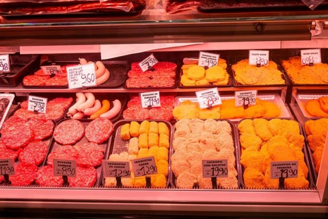 Market stall shop store selling butcher meat products inside Mercado Central de Zaragoza, Zaragoza,