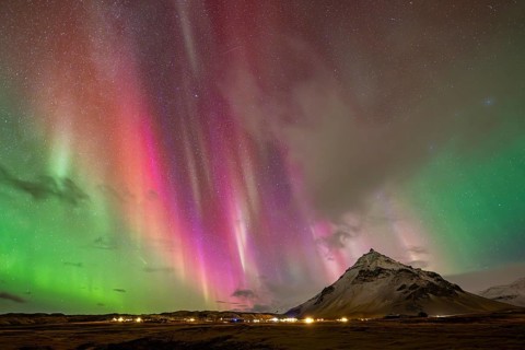 Northern lights, aurora borealis over mountain, Arnastapi, Iceland