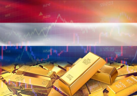 Gold bars on Netherlands flag in background. Gold bars stacked on Dutch flag. Concept of