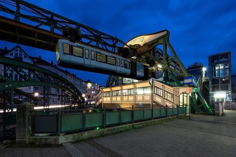 The Wuppertal suspension railway goes to the Werther Brücke stop, Wuppertal, Germany at blue hour,