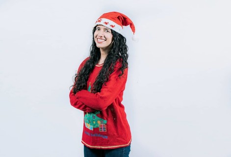 Smiling girl in Christmas hat with crossed arms. Portrait of smiling Latin girl in Christmas