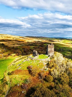 Autumn colours over Castell Dolwyddelan and Eryri Mountains from a drone, Snowdonia, Conwy County