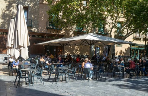 People sitting at tables and chairs in courtyard, Plaza de San Filipe, Zaragoza, Aragon, Spain