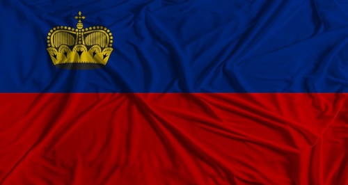 Liechtensteiner flag with fabric texture background. National flag of Liechtenstein with cloth