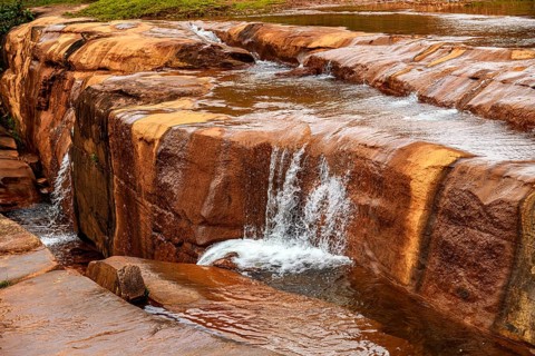 River flowing over rocks and forming small waterfalls in the state of Minas Gerais, Brazil, Minas