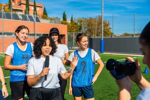 Female football player talking into a microphone, sharing her thoughts and insights about the