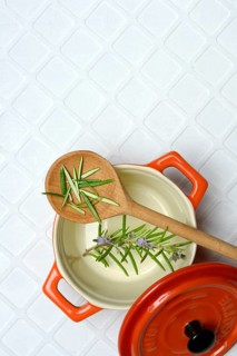 Rosemary, rosemary leaves on cooking spoon with cooking pot