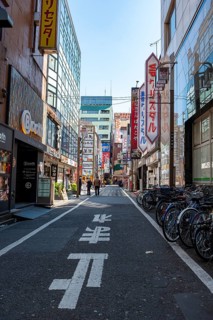 Street scene, lots of colorful signs of shops, restaurants and bars in a street, Shinjuku City,