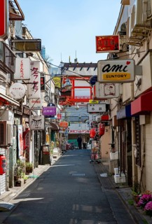 Lots of colorful signs of shops, restaurants and bars in a small alley, Shinjuku City, Tokyo, Japan