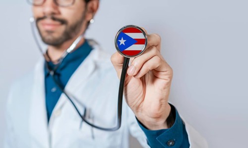 Doctor holding stethoscope with Puerto Rico flag. Puerto Rico health and care concept. Puerto Rico
