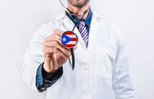 Puerto Rico healthcare system, doctor holding stethoscope. Puerto Rico health and medical insurance