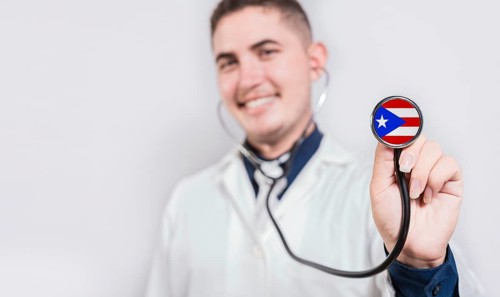 Doctor showing stethoscope with Puerto Rico flag. Puerto Rico national healthcare concept