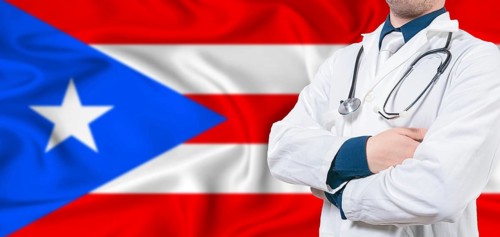 Puerto Rico healthcare concept. Male doctor on Puerto Rico flag. Doctor with crossed arms on Puerto