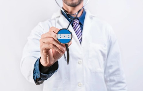 Honduras healthcare system, doctor holding stethoscope. Honduras health and medical insurance