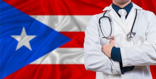 Male doctor with stethoscope on Puerto Rico flag. Doctor holding stethoscope on Puerto Rico flag