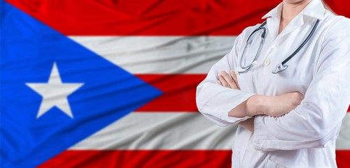 Doctor with crossed arms on Puerto Rico flag. Puerto Rico health and care concept. Female doctor on
