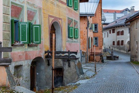 Engadin houses, historic houses, Dorstrasse with stones, village fountain, Guarda, Engadin,