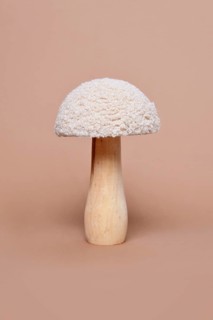 Single wooden and textile decorative mushroom object on beige background