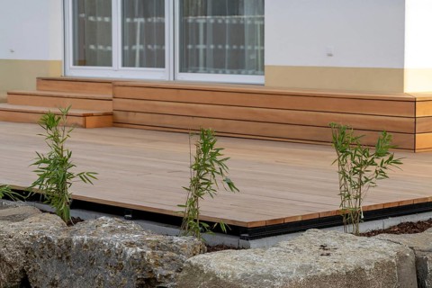 Beautiful wooden terrace on a newly landscaped garden