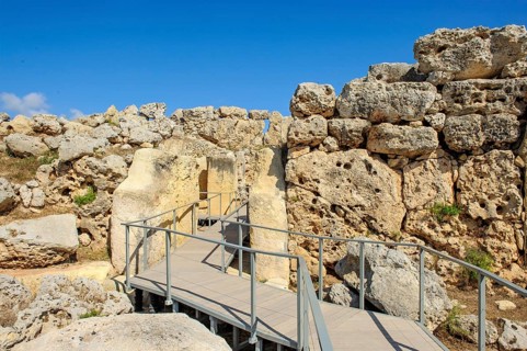 View from secured walkway with railing through ruins remains of Ggantija temple, UNESCO World