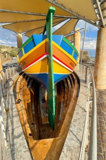 Monument to traditional fishing boats abandoned jacked up typical colorful painted old fishing boat