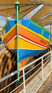 Monument to traditional fishing boats disused jacked up typical colorful painted old fishing boat