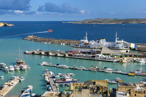 View from an elevated position of Mgarr harbour on the island of Gozo, large car ferry with open