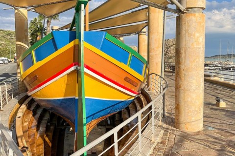 Monument to traditional fishing boats abandoned jacked up typical colorful painted old fishing boat