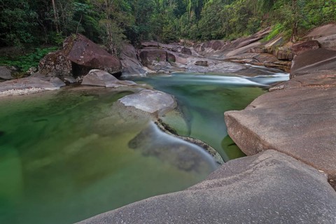 Turquoise blue water between rocks in the tropical rainforest of Babinda Boulders Queensland