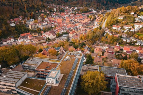 City view with various buildings, river and autumn trees from above, Calw District Office, Calw,