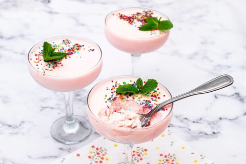 Fruit mousse, made from jelly and cottage cheese, in glasses, decorated with sprinkles and mint,