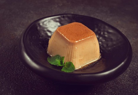 Cream caramel pudding, with caramel sauce, dessert, breakfast, on a black plate, mint, no people