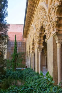 Ornate Islamic design decorated Moorish arches, courtyard garden of Santa Isabel, Aljafería Palace,