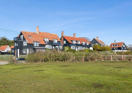 Wooden houses of The Dunes in planned seaside holiday village of Thorpeness, Suffolk, England, UK c