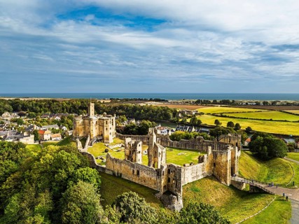 Warkworth Castle over River Coquet from a drone, Warkworth, Northumberland, England, United Kingdom