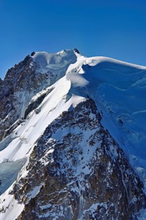 A group of mountaineers runs across a snow-covered mountain, Aiguille du Midi, Chamonix-Mont-Blanc,