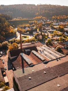 Aerial view of an industrial site in autumn with old buildings and trees, Nagold, Black Forest,