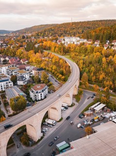 Aerial view of a small town with a viaduct surrounded by forests in autumn colors, Nagold, Black