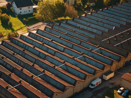Industrial roof structure with a delivery vehicle in an autumn light, seen from the air, Nagold,
