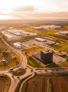Roundabout and industrial park, in golden evening light, surrounded by fields and nature, Nagold,