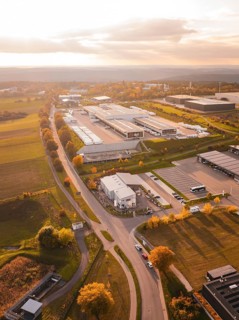 Roads lead through an industrial park with isolated buildings and adjacent fields, DPD, Nagold,